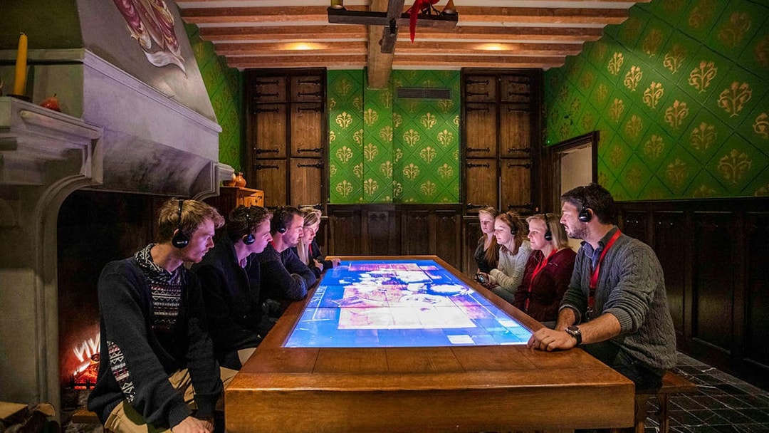 Visitors engaging with interactive display at Historium Bruges, Belgium.