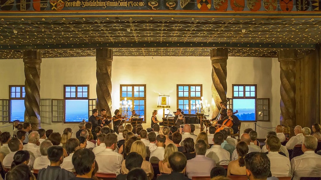 Concert audience at Fortress Hohensalzburg enjoying a Mozart performance.