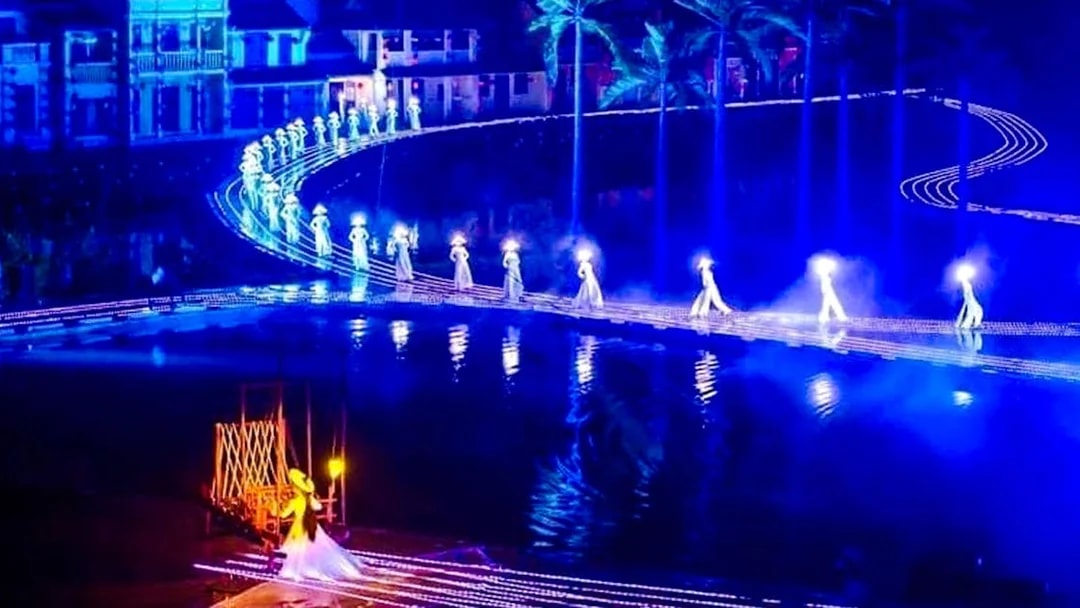 Performers in illuminated costumes on stage at Hoi An Memories Show, Vietnam.
