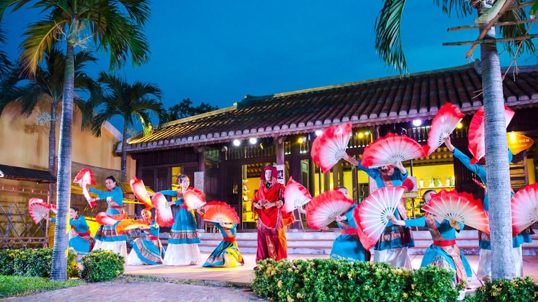 Performers with red fans at Hoi An Memories Show, Vietnam.