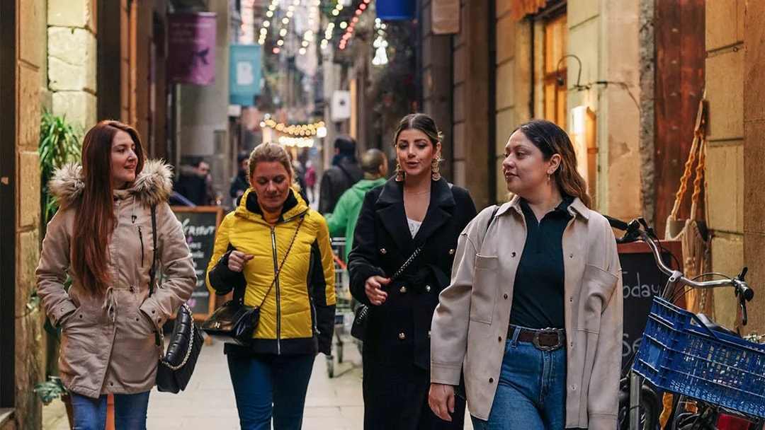 Group walking through a narrow street in Barcelona during a guided tour.