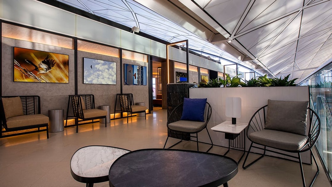 Plaza Premium Lounge seating area with modern decor and wall art.