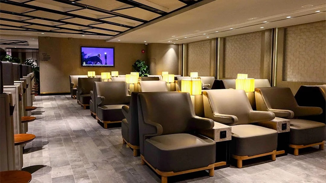 Plaza Premium Lounge seating area with armchairs and lamps.