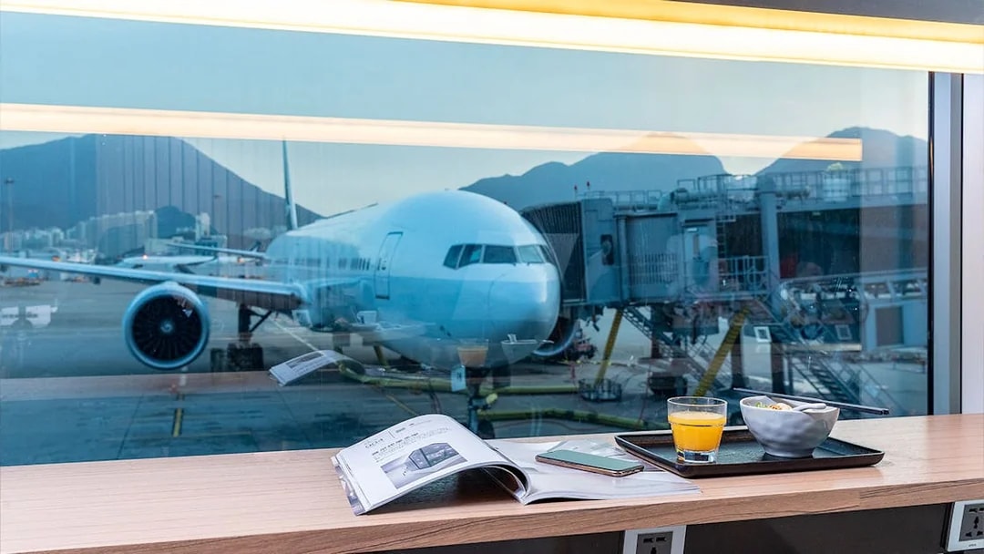 Airplane view from Plaza Premium Lounge with breakfast and magazine.