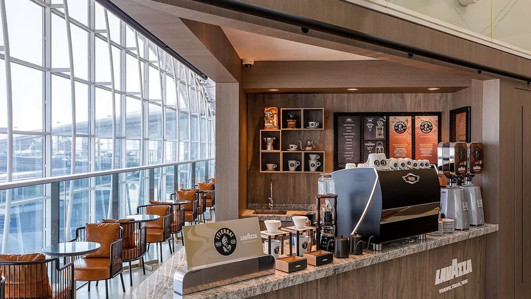 Plaza Premium Lounge coffee bar with Lavazza machine and seating area.