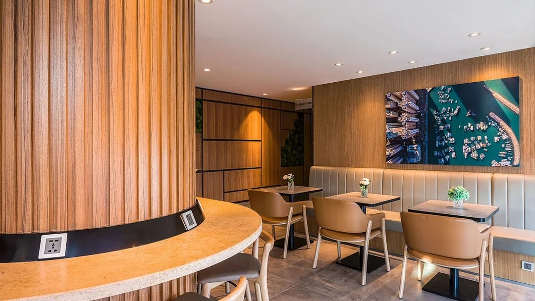 Plaza Premium Lounge seating area with wooden decor and wall art.
