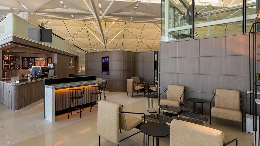 Plaza Premium Lounge seating area with modern decor and coffee bar.