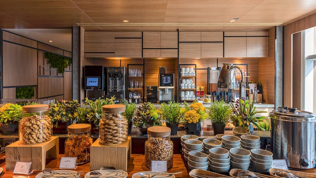 Buffet setup with snacks and beverages at Plaza Premium Lounge.