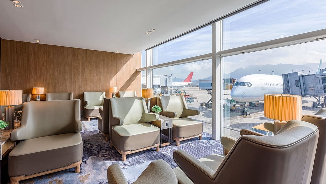 Plaza Premium Lounge seating area with airport runway view.