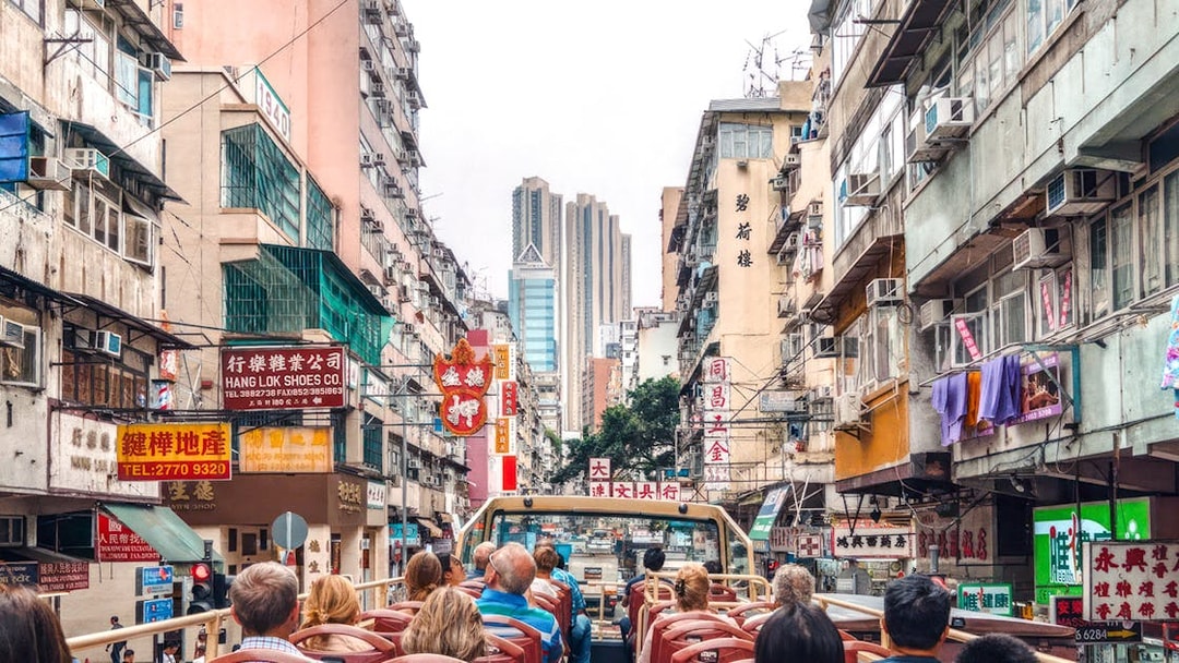 Guests on a Big Bus tour in Hong Kong, viewing bustling city streets and high-rise buildings.