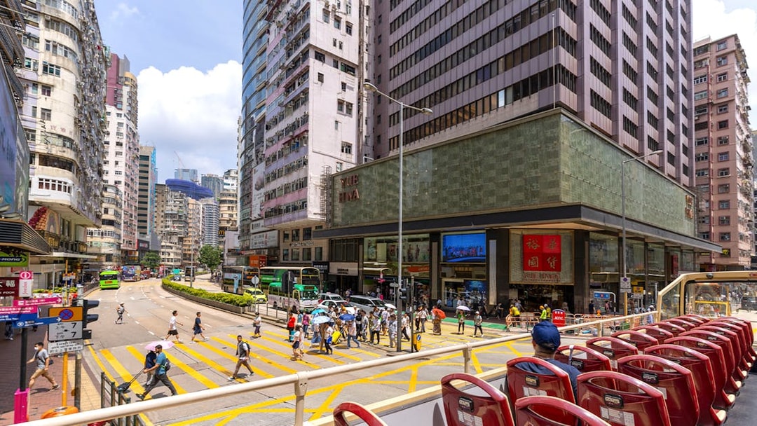 Guests on the Big Bus tour in Hong Kong, viewing city streets and skyscrapers.