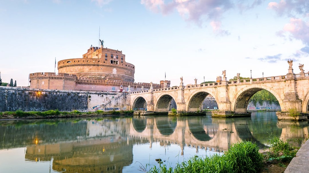 Castel Sant'Angelo and Ponte Sant'Angelo at sunset in Rome.