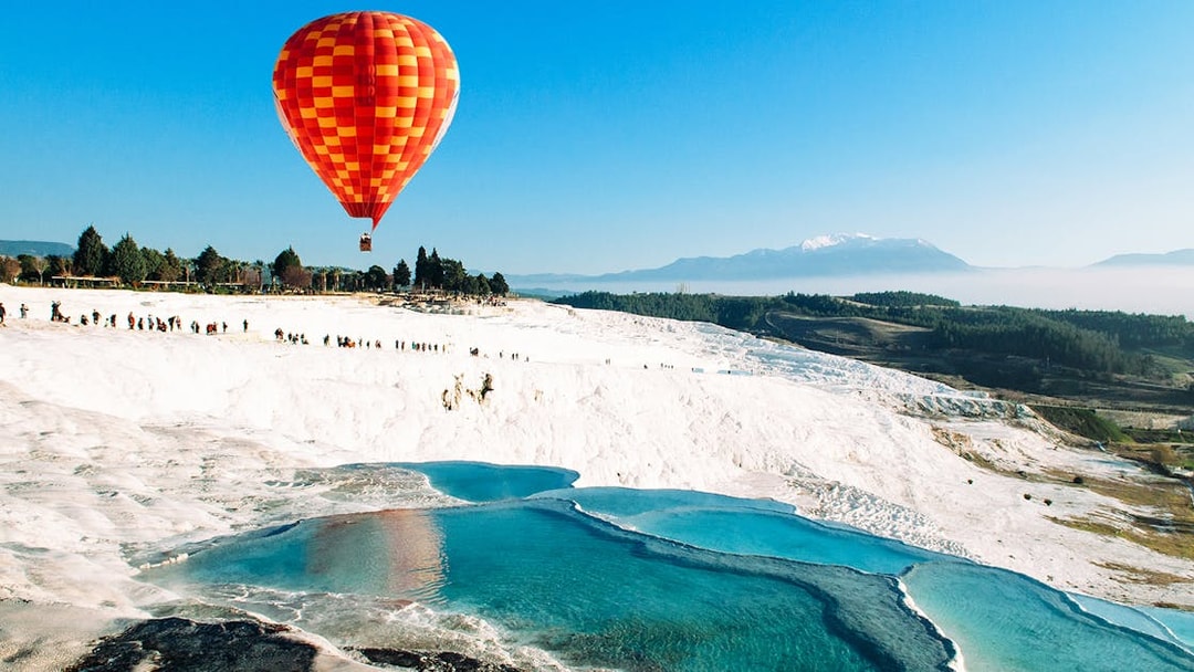 Hot air balloon over Pamukkale's travertine terraces, Turkey.