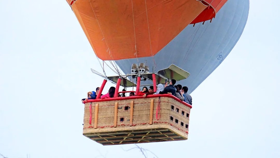 Hot air balloon with passengers in flight over Pamukkale.