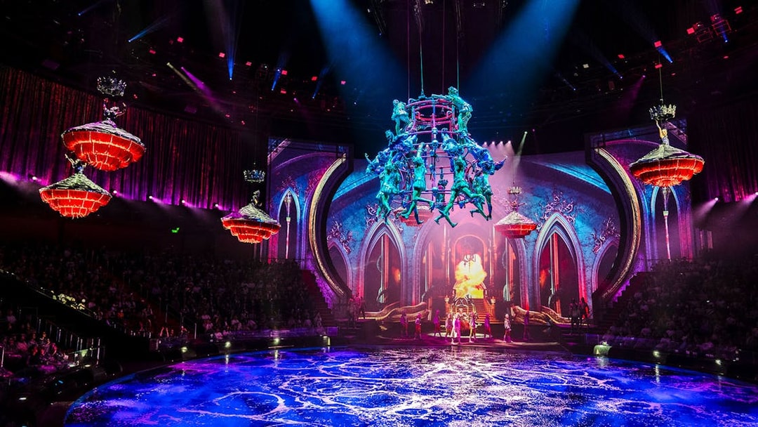 Acrobats performing above water stage during House of Dancing Water show.