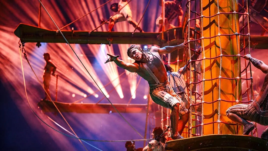 Acrobats performing on ropes and platforms during House of Dancing Water show.