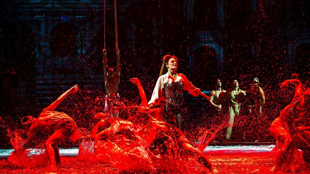 Performers splashing water during House of Dancing Water show.