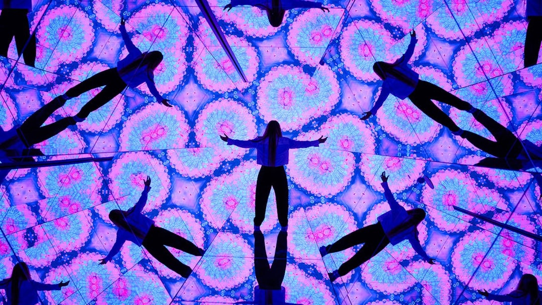 Visitors interacting with mirrored digital displays at House of Hype.