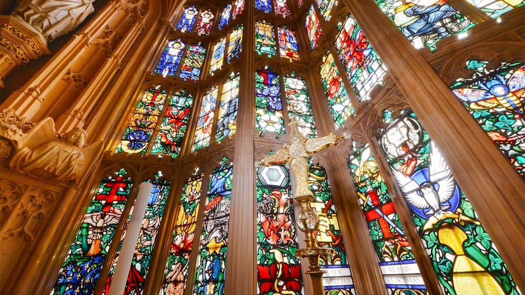 Stained glass windows and ornate carvings inside Westminster Abbey.