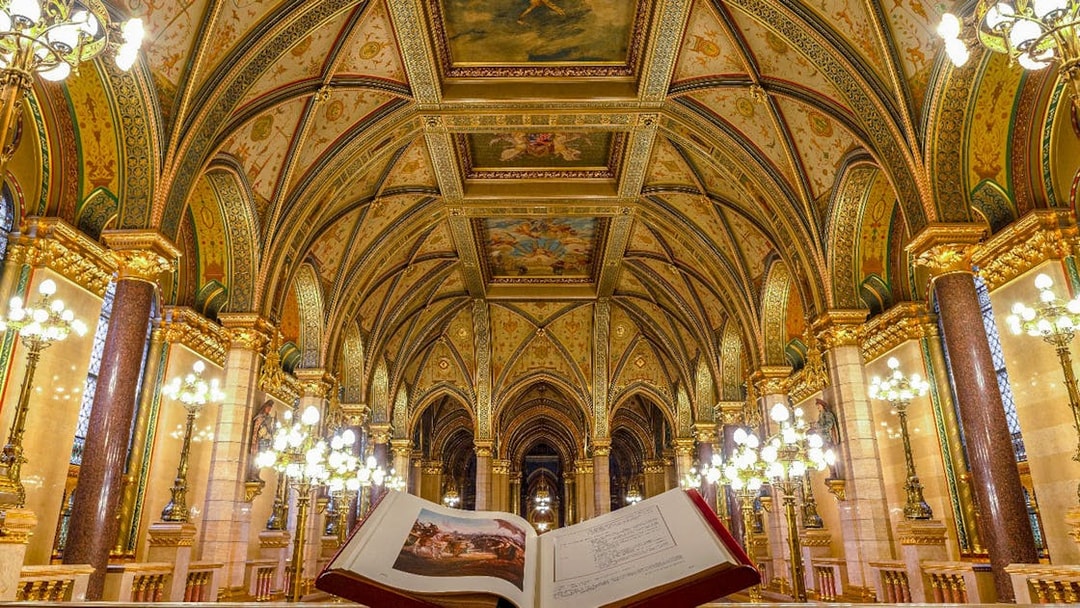Hungarian Parliament interior with ornate ceiling and open book, Budapest audio tour.