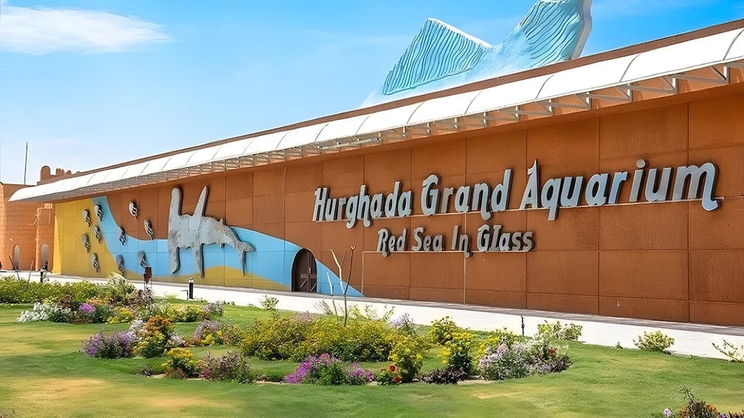 Hurghada Grand Aquarium entrance with colorful mural and garden.