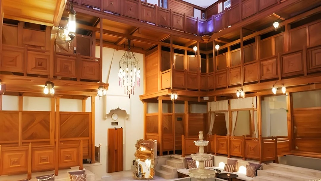 Hurrem Sultan Hamam interior with wooden decor and central fountain in Istanbul.