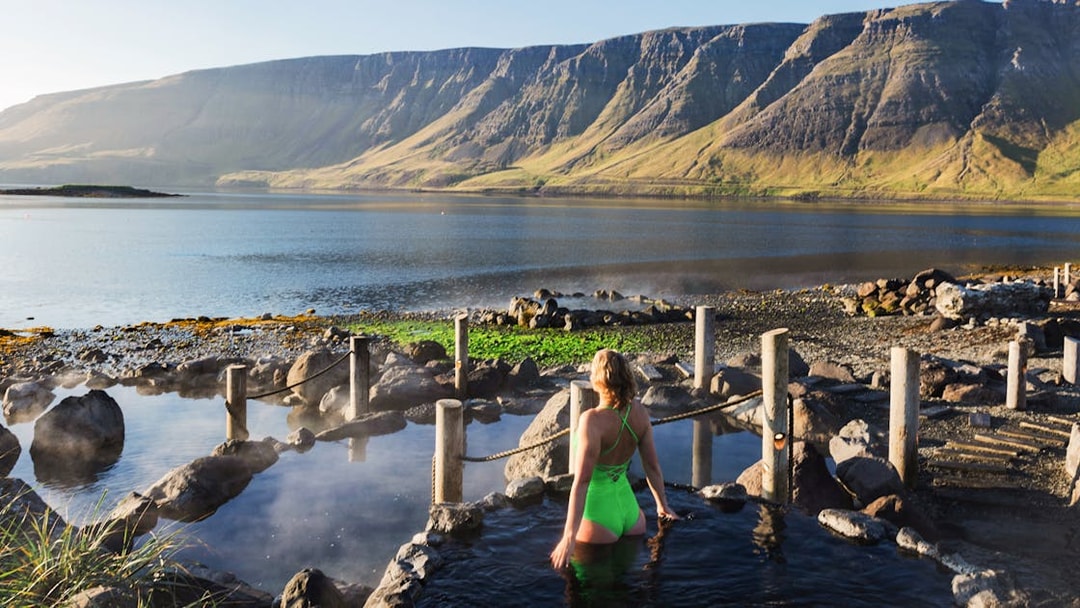 Hvammsvík Hot Spring with view of mountains and lake near Reykjavík.