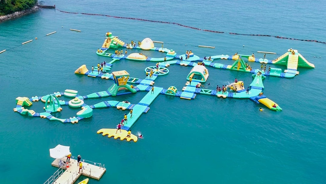 Floating water obstacle course at HydroDash Singapore with participants enjoying activities.