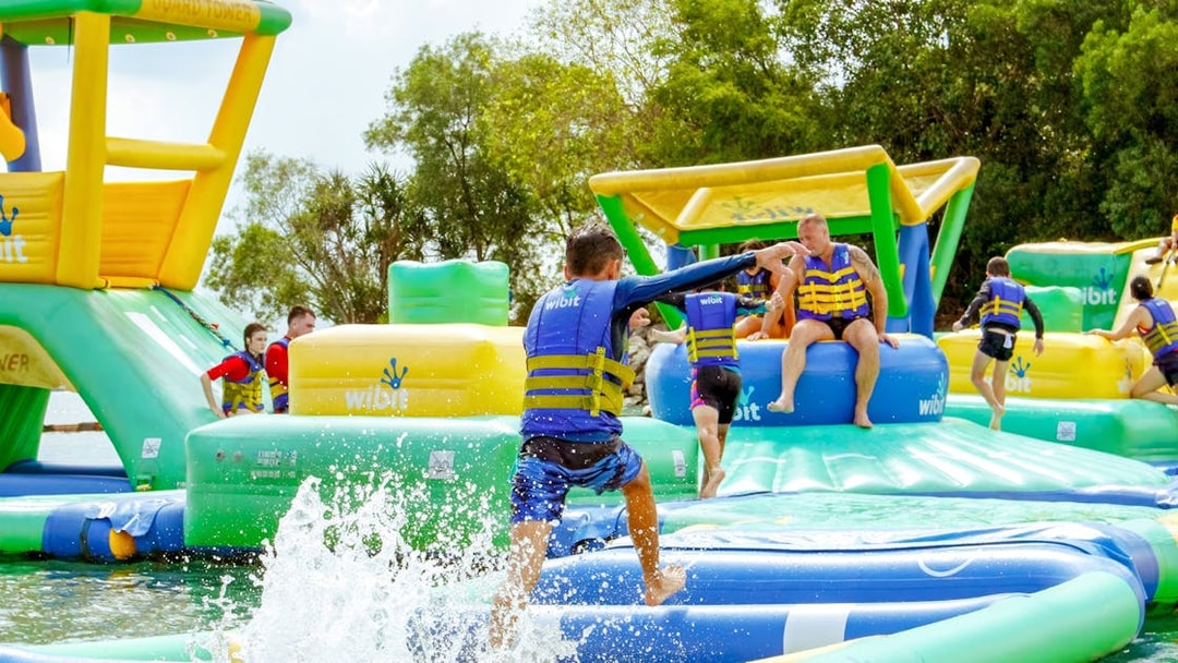 Visitors enjoying inflatable water park activities at HydroDash Singapore.