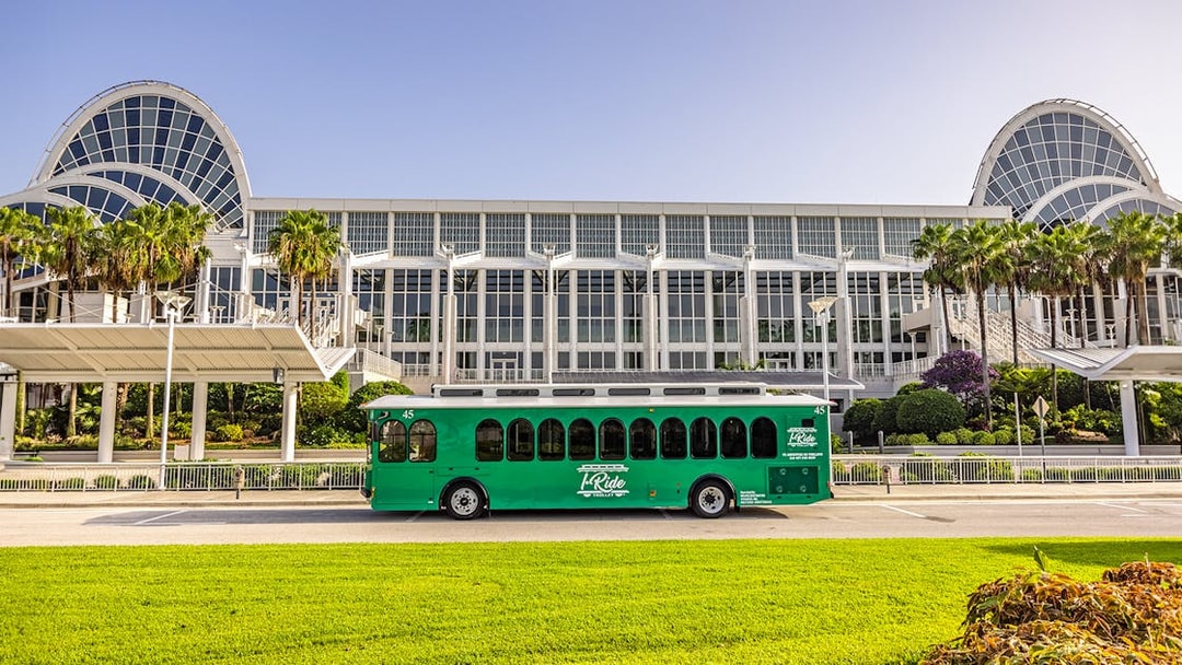 Green trolley in front of Orange County Convention Center, Orlando.