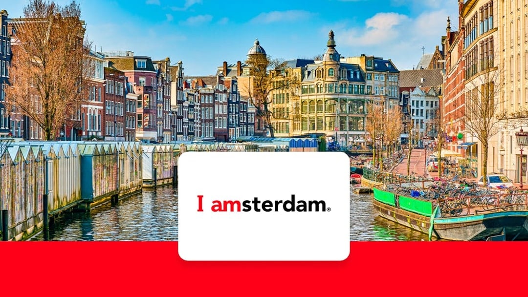 Amsterdam canal with historic buildings and bicycles in early spring.