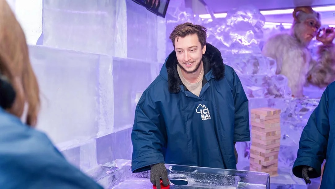 Man playing ice shuffleboard at IceBar Surfers Paradise.