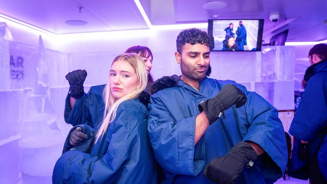 Visitors in blue coats enjoying IceBar Surfers Paradise.