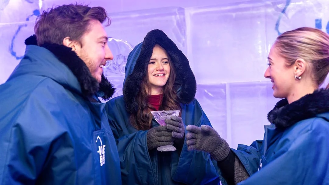 Visitors in winter coats enjoying drinks at IceBar Surfers Paradise.