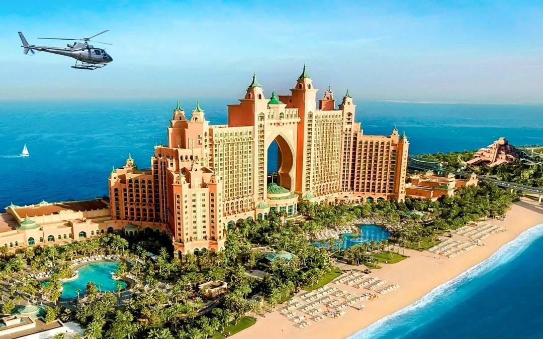 Helicopter flying over Atlantis, The Palm in Dubai with ocean view.