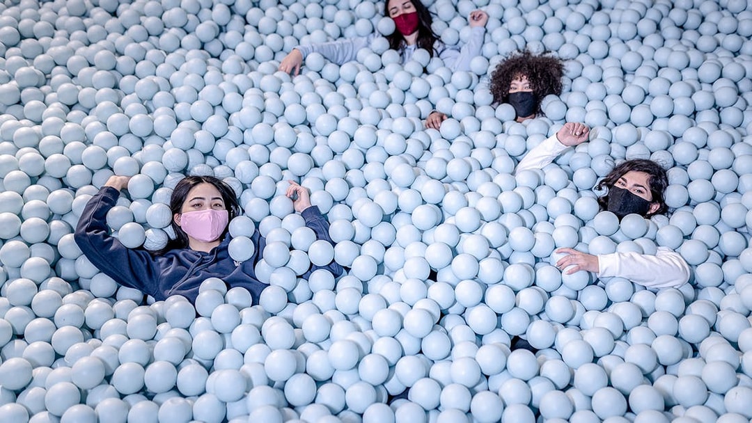 Visitors enjoying a ball pit at Ikono in Madrid.