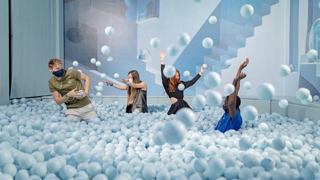 Visitors enjoying a ball pit at Ikono in Madrid.