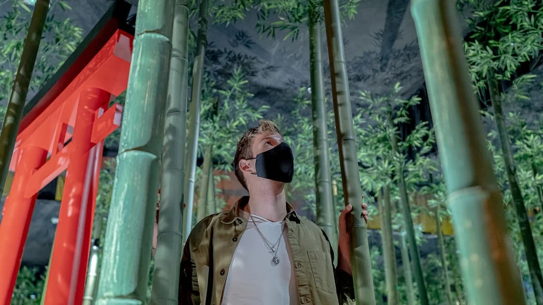 Person exploring bamboo installation at Ikono in Madrid.