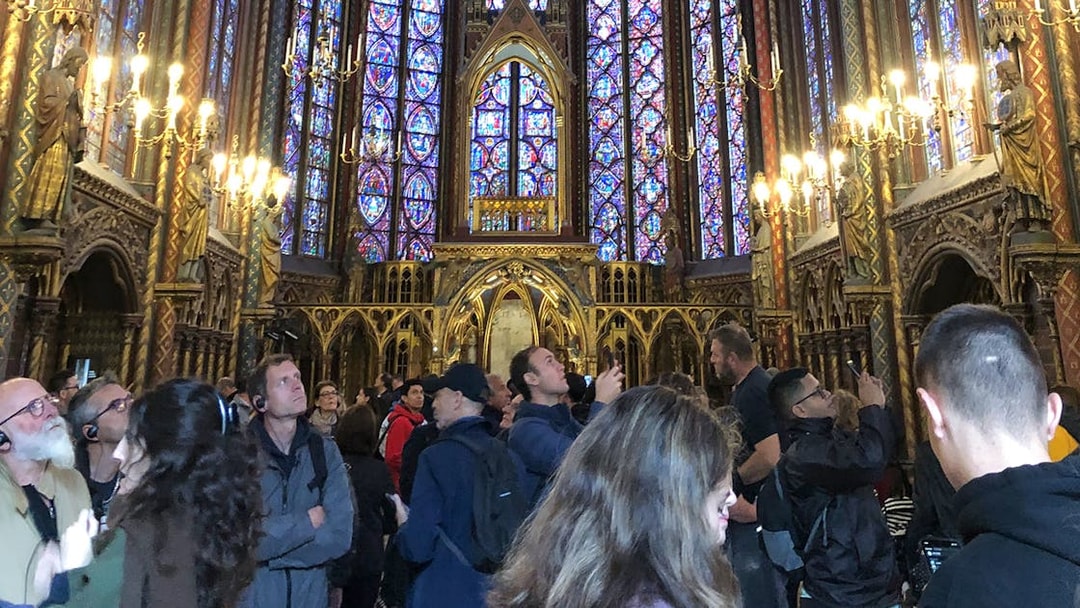 Visitors admire stained glass windows inside Sainte Chapelle, Paris.