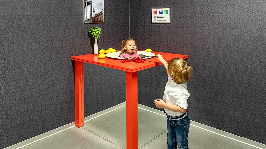 Child interacting with optical illusion exhibit at Illuseum Berlin.