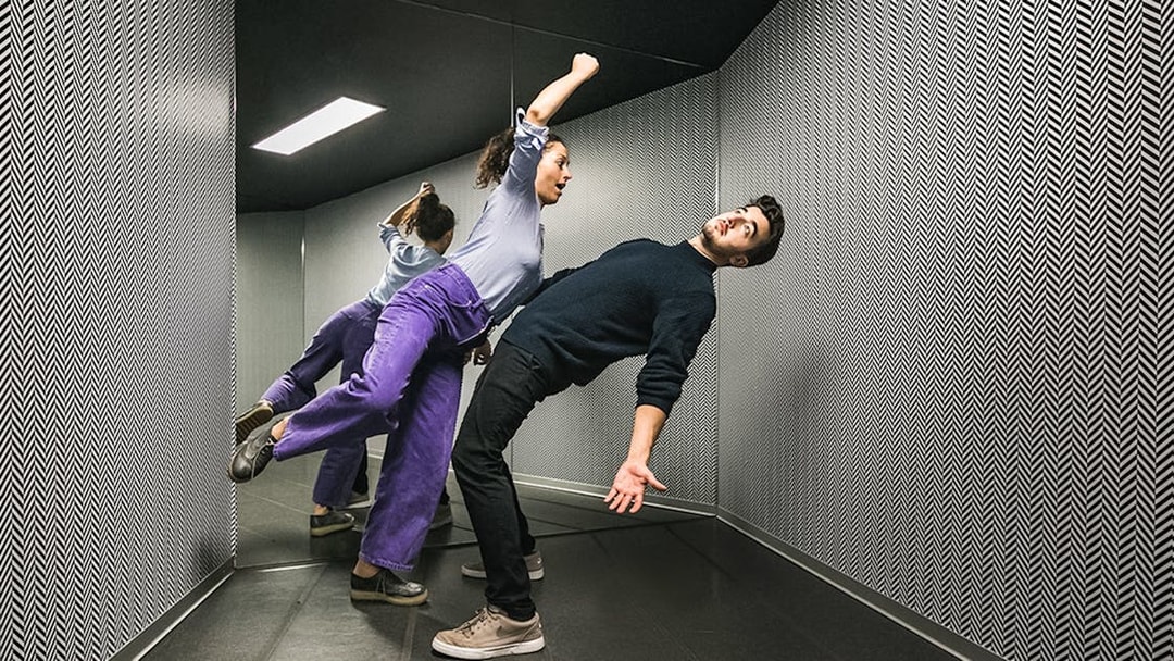 Visitors experiencing the anti-gravity room at Illuseum Berlin.