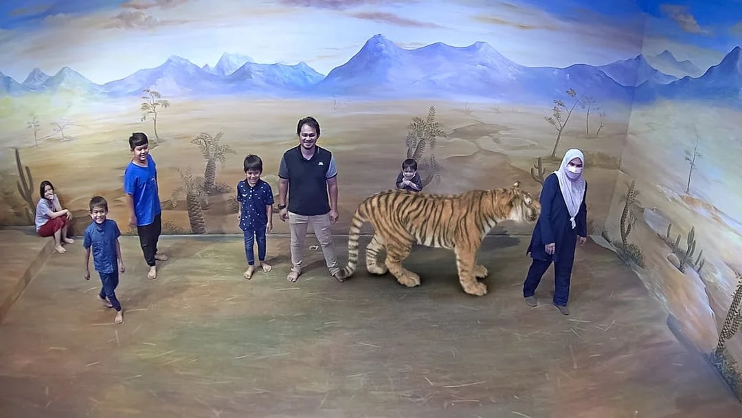 Visitors interacting with 3D tiger art at Illusion 3D Art Museum Kuala Lumpur.
