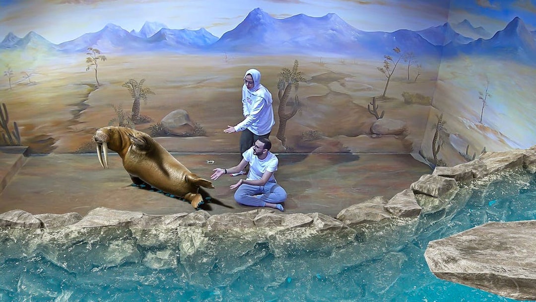 Visitors interacting with a 3D walrus art piece at Illusion 3D Art Museum Kuala Lumpur.