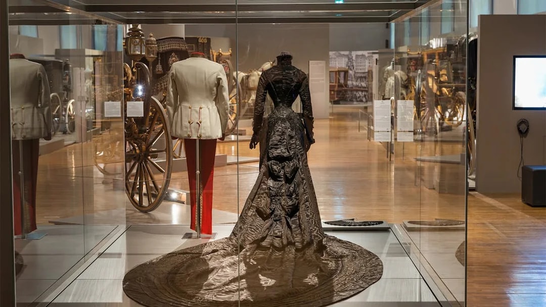 Imperial Carriage Museum display with historical attire and carriages at Schönbrunn Palace.