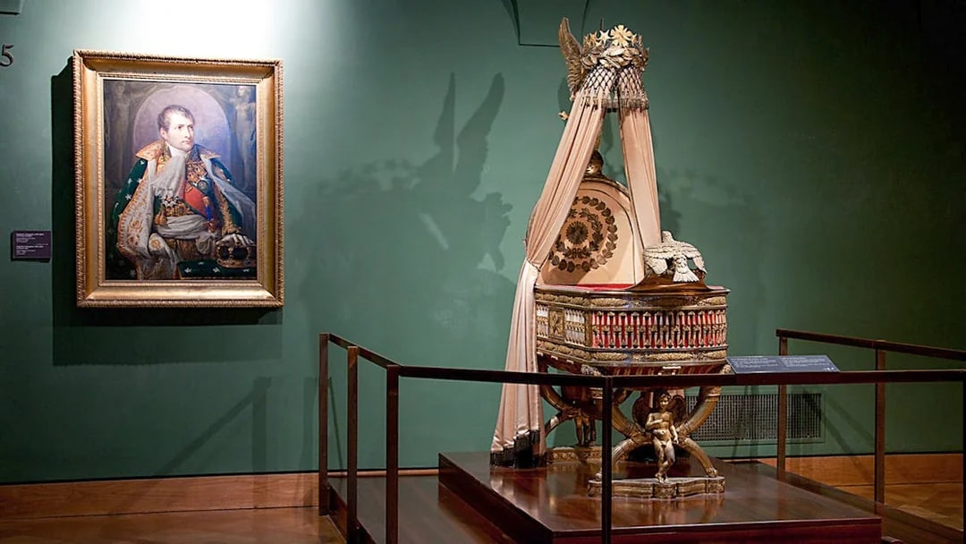 Portrait and imperial cradle display at Imperial Treasury Vienna.