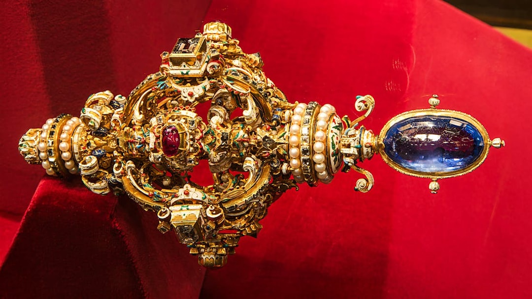 Ornate jeweled scepter with pearls and gemstones at Imperial Treasury Vienna.