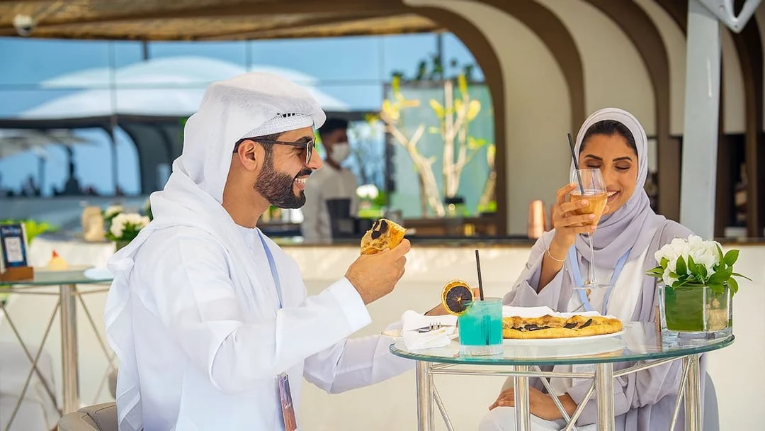 Guests enjoying beverages and snacks during a guided tour inside Burj Al Arab, Dubai.