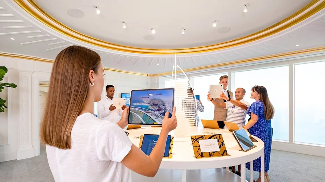 Visitors using tablets during a guided tour inside Burj Al Arab, Dubai.