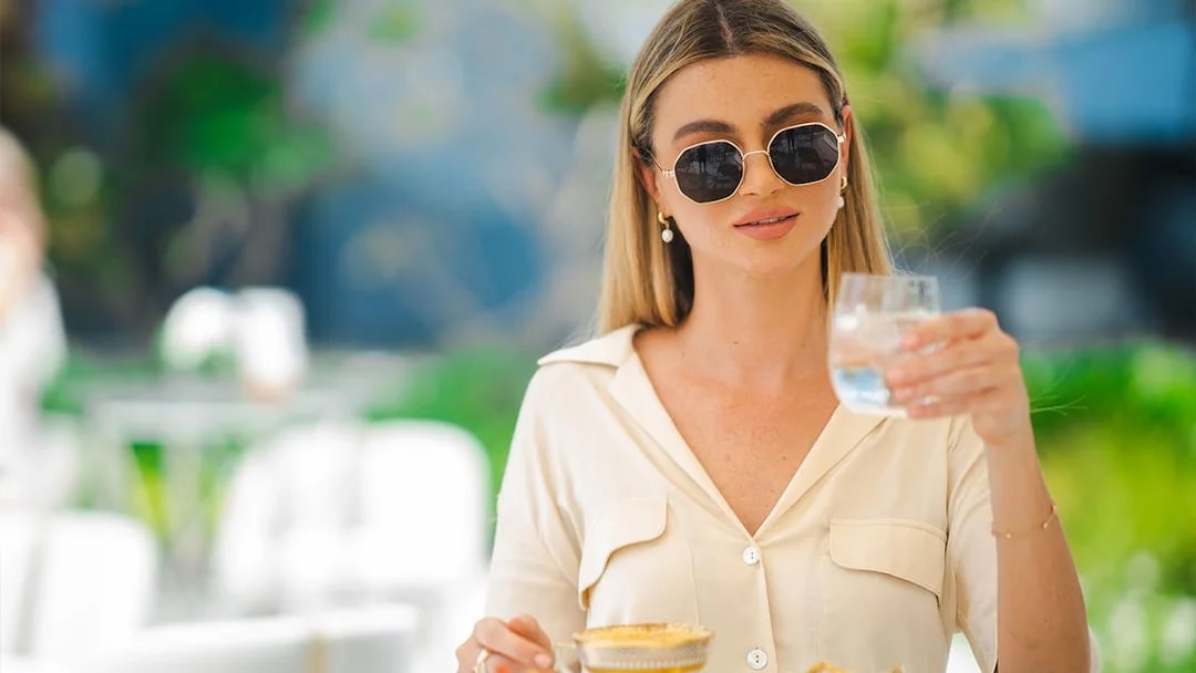 Guest enjoying a beverage during a guided tour inside Burj Al Arab.