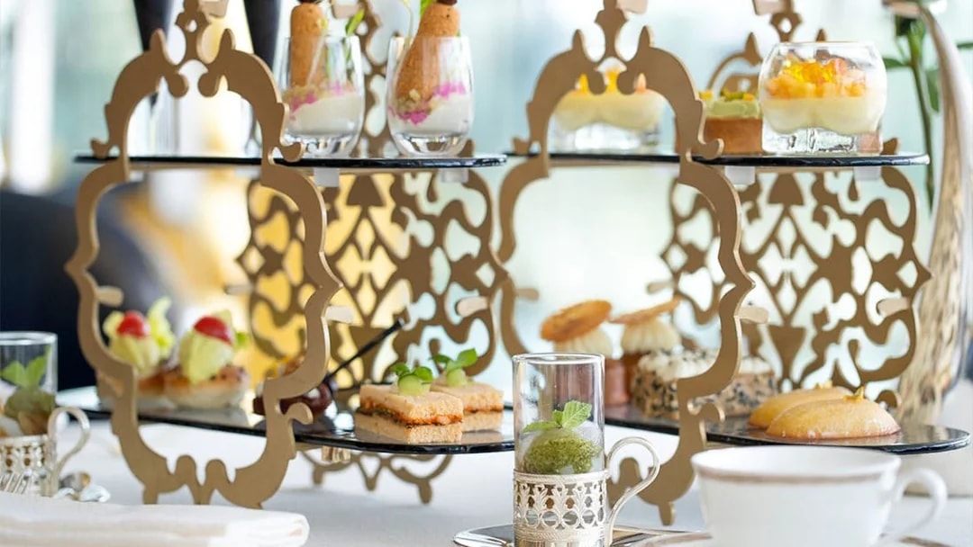 Afternoon tea setup with desserts and beverages at Burj Al Arab tour.